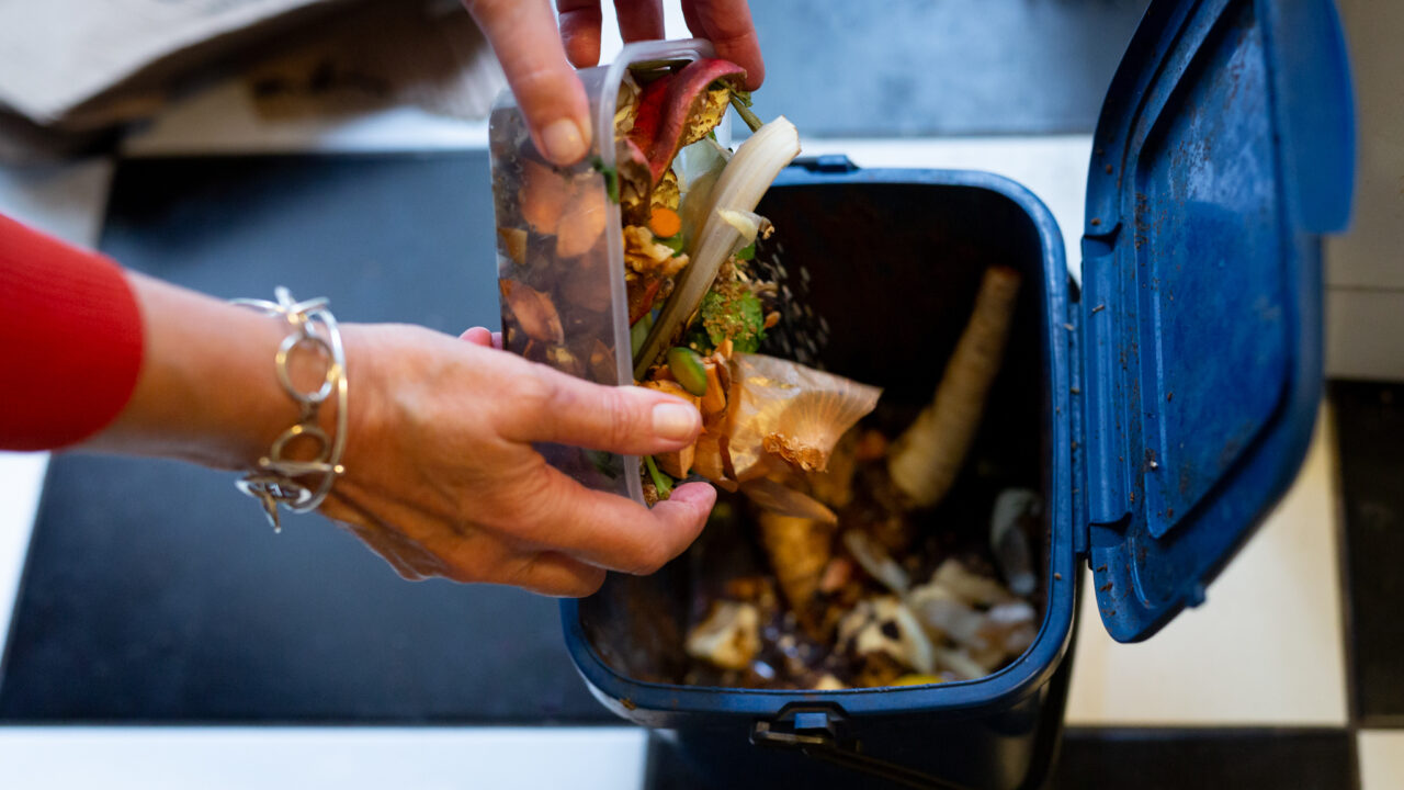 Putting food waste into a food waste bin